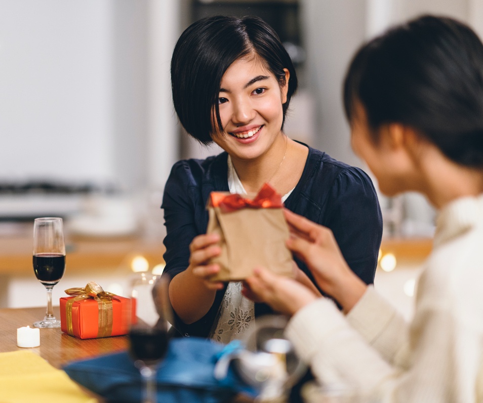Group of women friends giving gifts to each other