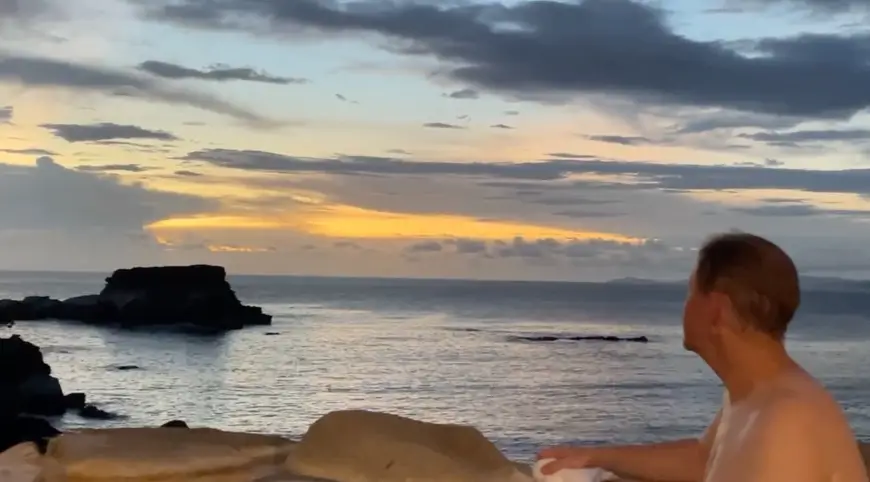 Man looking at ocean from hot spring tub in Wakayama Japan
