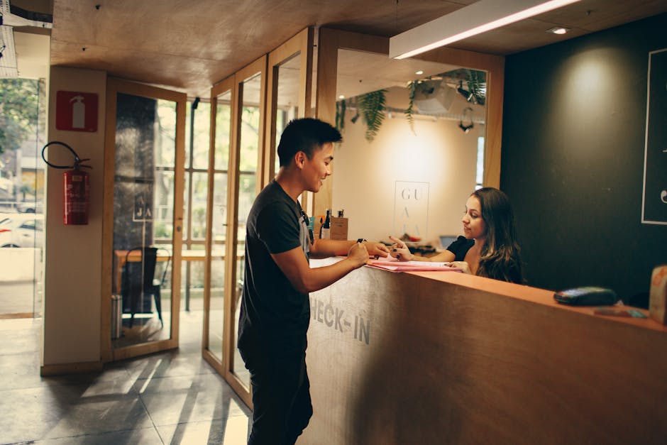 A customer checks in at a hotel reception desk in Belo Horizonte, Brazil.