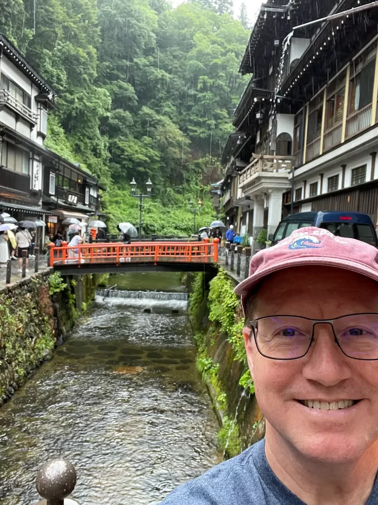 Man by river at Ginzan Onsen in Yamagata Japan